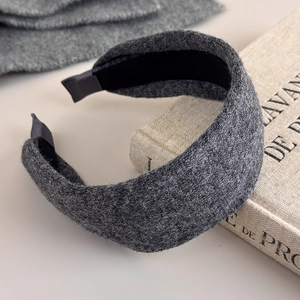 Detailed texture of thick dark grey wool knit headband with elegant wide brim design
