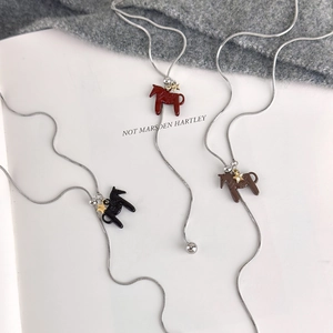 Detail of horse pendant necklaces with metal glaze finish on a silver snake chain