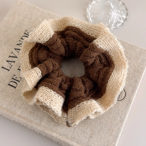 Close-up of contrast-color knitted hair scrunchie with ribbed texture detail