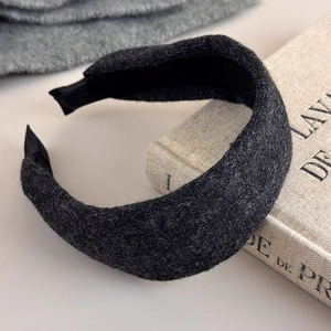 Detailed macro view of dark grey thick knitted headband with black non-slip inner lining