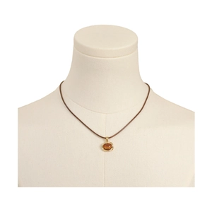 Vintage tiger eye pendant necklace on a brown cord displayed on a white mannequin