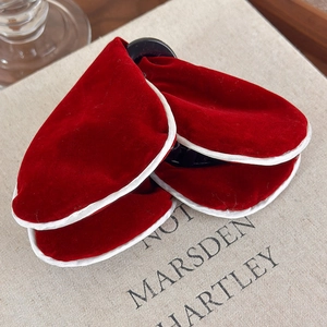 Detail of red velvet butterfly hair claws with white fabric edges in a retro style