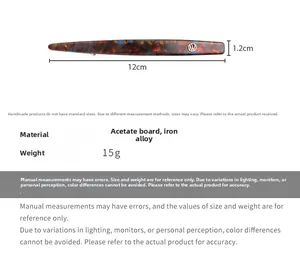 Macro detail of tortoiseshell acetate hair clip with gold logo and 12cm dimensions