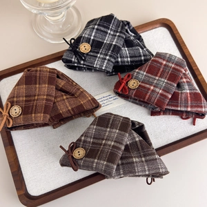 Retro plaid bow hair claws in various colors with vintage wooden buttons set on a tray