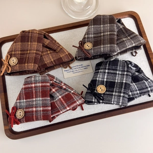 Detail of four plaid hair claws with wooden buttons and bowknots in vintage retro style