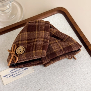 Close-up of vintage brown plaid hair claw with wooden button and bow detail