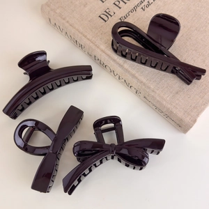 Set of four chocolate brown hair claws featuring elegant bow and minimalist curved designs