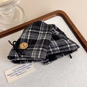 Detailed view of British vintage plaid hair clip with wooden button and bow ornament