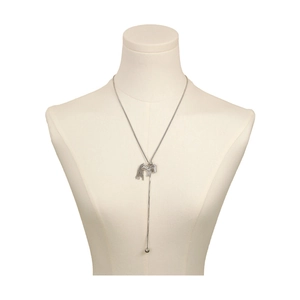 Detail of silver horse pendant necklace with shimmering crystals and tassel on a long chain