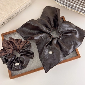 Brown faux leather and leopard print scrunchie set with decorative metal labels