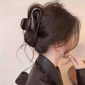 Chocolate brown bow hair claw clip for women shown in a stylish updo hairstyle
