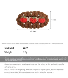 Detail view of handmade crochet hair clip with red strawberries and size dimensions