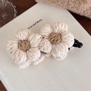 Detail of handmade crochet wool flower on banana hair clip with high-quality texture