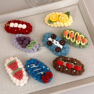Handmade crochet fruit hair clips set featuring strawberry lemon and grape knit designs