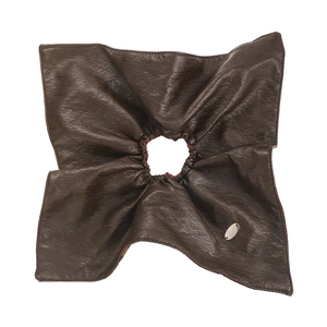 Detailed view of large dark brown leather scrunchie with silver oval metallic nameplate