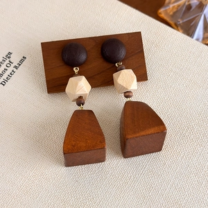 Detailed view of vintage geometric wooden drop earrings with mixed brown wood tones