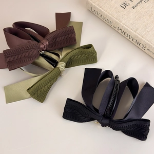 Detail of vintage knit bow banana clips in coffee, olive, and black with non-slip teeth