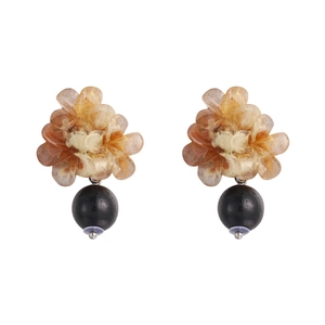 Detail view of retro wood-woven geometric earrings with amber resin petals and black bead drops