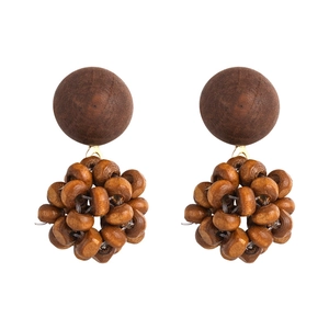 Detailed view of bohemian vintage wooden beaded earrings with natural brown texture