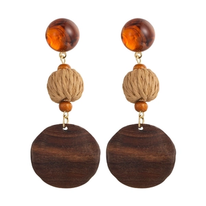 Vintage bohemian earrings with amber resin, woven straw balls and dark wood circular pendants