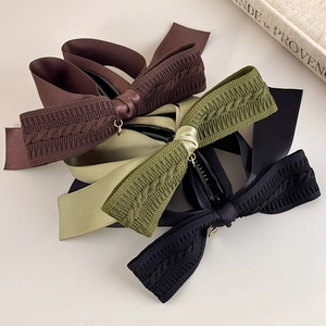Detail of vintage knit bow banana clips in coffee brown, olive green and black