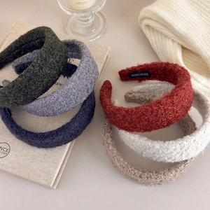 Thick plush lamb wool headbands in various autumn colors with handmade label detail