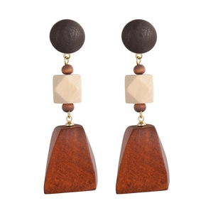 Detailed view of geometric wooden earrings with spheres cubes and trapezoid blocks