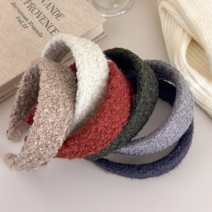 Detailed collection of plush lamb wool headbands in six cozy autumn colors on a table