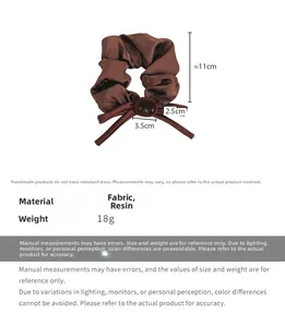 Detail view of brown silk scrunchie with plush bear charm and measurements of 11cm