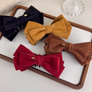 Elegant suede velvet bow hair clips in multiple retro colors with gold metal love detail