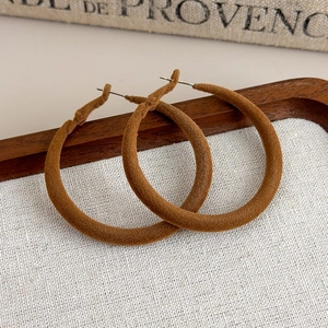 Detail of winter camel velvet flocking on large hoop earrings with metal posts