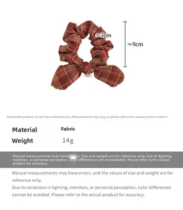 Detailed view of red plaid bow scrunchie showing fabric texture and 9cm size dimensions