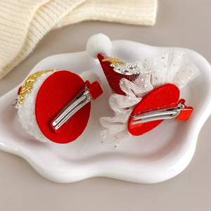 Detailed close-up of Christmas hair clips with sequins and mesh on a ceramic plate