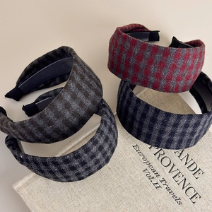 Vintage checkered wide headbands set in autumn wool fabric on retro book background