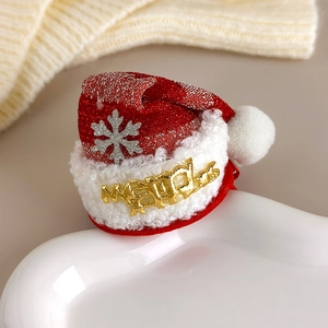 Detail of red mesh Christmas hat hair clip with Merry text and snowflake glitter