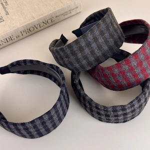 Detail view of retro plaid headbands with non-slip inner teeth in various classic patterns