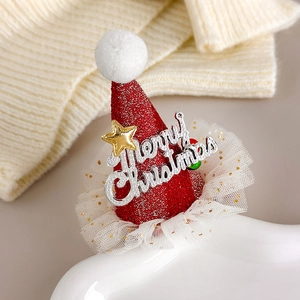 Detail of red glitter Christmas hat hair clip with gold stars and white mesh lace