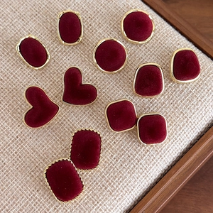Detail view of vintage burgundy velvet square earrings with elegant gold metal edges