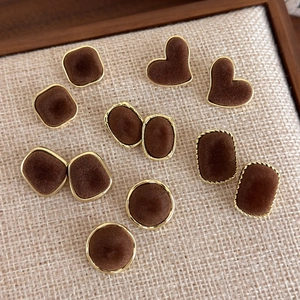 Detailed view of vintage brown velvet geometric stud earrings with gold-tone borders