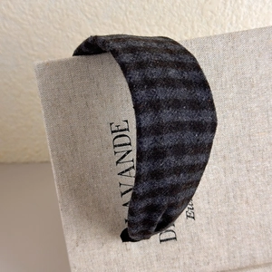 Detail of dark grey striped wide headband with soft wool-like texture for women
