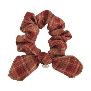 Vintage red plaid bow scrunchie with retro metal tag for a stylish preppy hairstyle