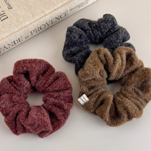 Three-piece set of plush wool scrunchies in burgundy, grey, and brown for hair styling