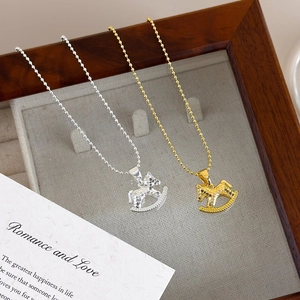 Golden and silver rocking horse pendant necklaces with textured finish on beaded chains