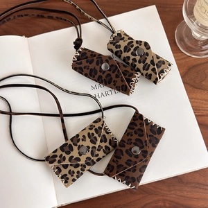 Detailed close-up of leopard print mini bags with premium suede texture and stitching