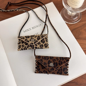 Detail view of retro leopard print mini bags with fine stitching and leather lanyard