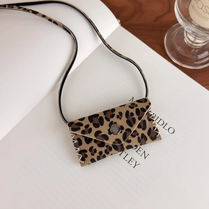 Detailed shot of leopard print mini bag accessory with stitching and magnetic closure