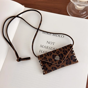 Detail of leopard print mini bag pendant with metallic clasp and white contrast stitching