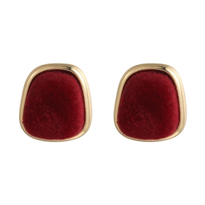 Close-up of vintage square velvet earrings with gold metal trim in deep burgundy finish
