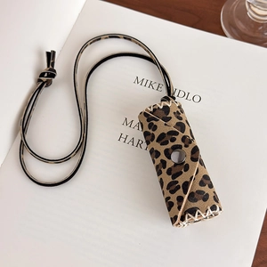 Close-up of leopard print lipstick holder necklace with textured finish and metal snap
