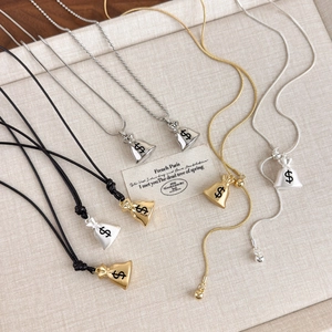 Detailed close-up of lucky money bag pendants in various metallic finishes and chain styles